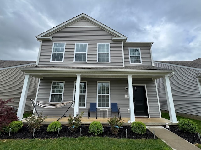 traditional-style home featuring covered porch