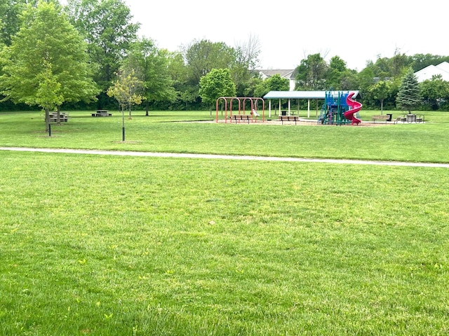 view of property's community with a yard
