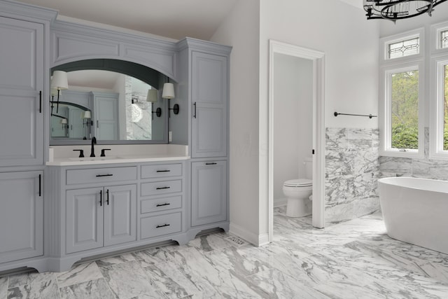 7870 Cook Rd, Plain City, OH 43064 - full bathroom featuring a freestanding tub, marble finish flooring, vanity, a chandelier, and toilet