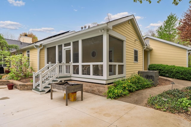 7870 Cook Rd, Plain City, OH 43064 - back of property featuring central air condition unit, a sunroom, and a patio area