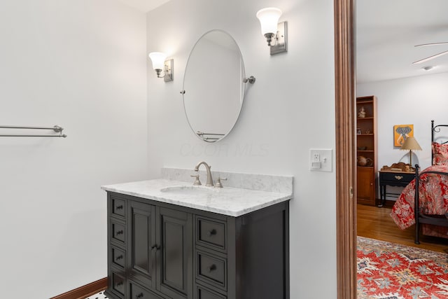 7870 Cook Rd, Plain City, OH 43064 - ensuite bathroom with vanity, wood finished floors, and ceiling fan