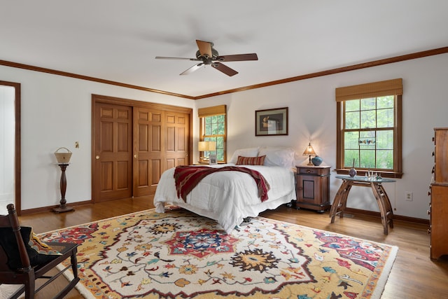7870 Cook Rd, Plain City, OH 43064 - bedroom featuring wood finished floors, baseboards, ornamental molding, a ceiling fan, and a closet