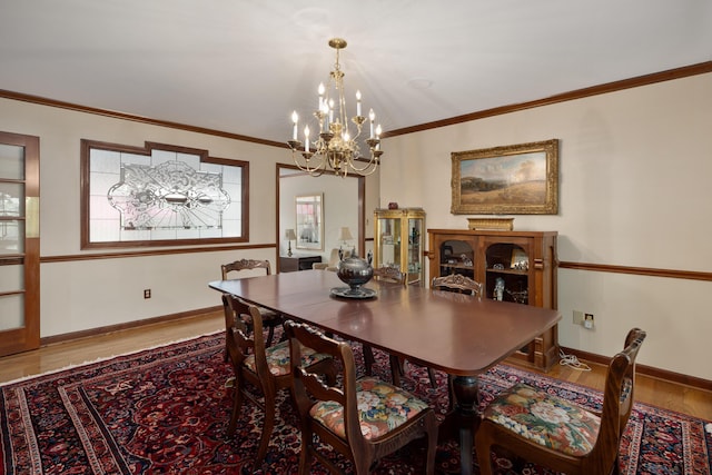 7870 Cook Rd, Plain City, OH 43064 - dining area featuring wood finished floors, a chandelier, baseboards, and crown molding