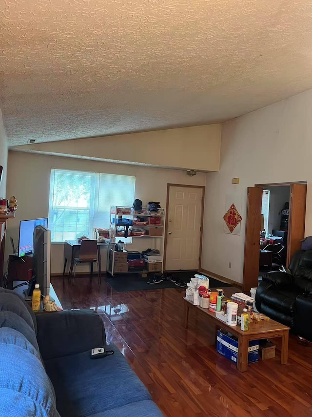 living area featuring vaulted ceiling, wood finished floors, a textured ceiling, and an office area