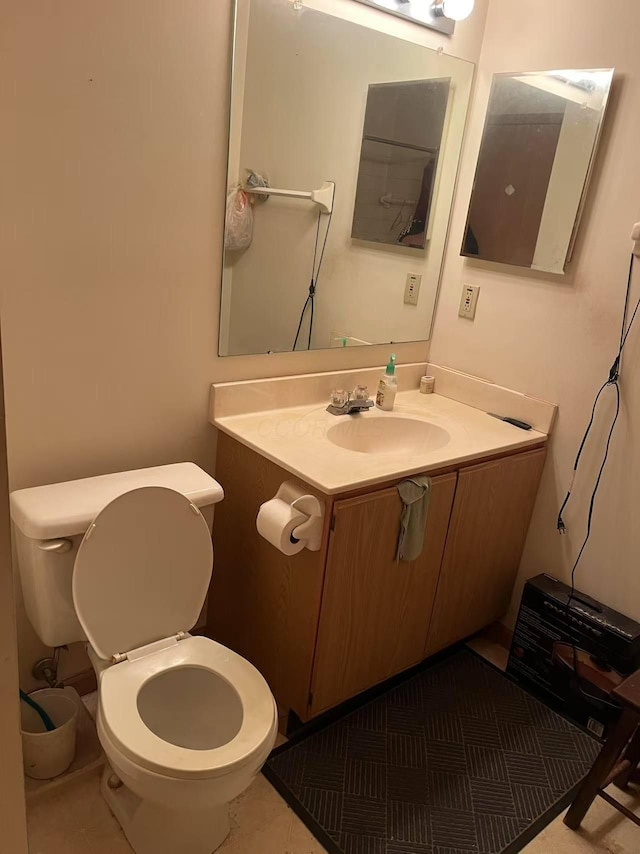 bathroom featuring toilet and vanity