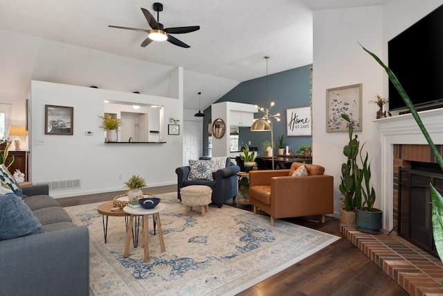 5372 Thistledown Dr, Columbus, OH 43221 - living area featuring dark wood-style floors, ceiling fan, vaulted ceiling, a fireplace, and baseboards