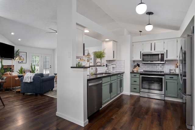 5372 Thistledown Dr, Columbus, OH 43221 - kitchen with appliances with stainless steel finishes, lofted ceiling, open floor plan, dark countertops, and decorative backsplash