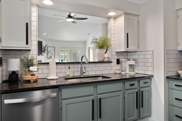 5372 Thistledown Dr, Columbus, OH 43221 - kitchen with stainless steel dishwasher, a sink, a ceiling fan, backsplash, and dark stone countertops