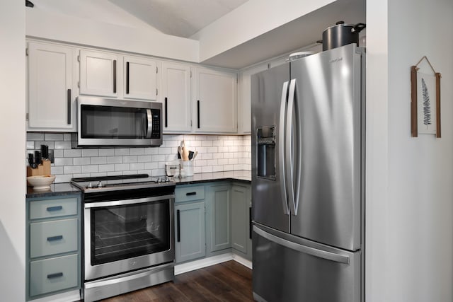 5372 Thistledown Dr, Columbus, OH 43221 - kitchen featuring stainless steel appliances, dark countertops, decorative backsplash, dark wood-style flooring, and white cabinets