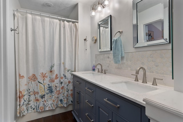 5372 Thistledown Dr, Columbus, OH 43221 - full bath with backsplash, double vanity, a textured ceiling, curtained shower, and wood finished floors