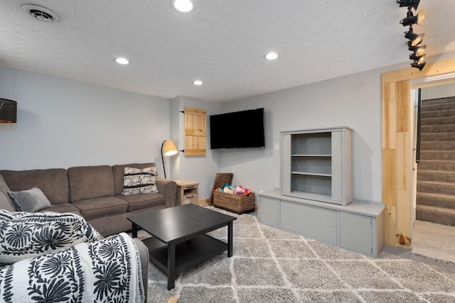 5372 Thistledown Dr, Columbus, OH 43221 - carpeted living room featuring stairway, recessed lighting, and a textured ceiling