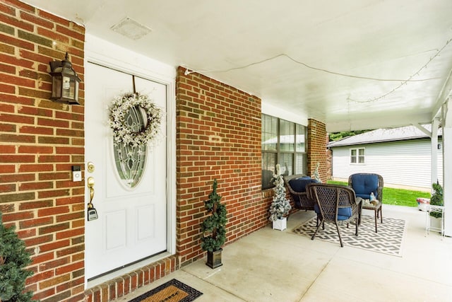 696 Brenton Pl, Columbus, OH 43213 - property entrance featuring a porch, brick siding, and visible vents