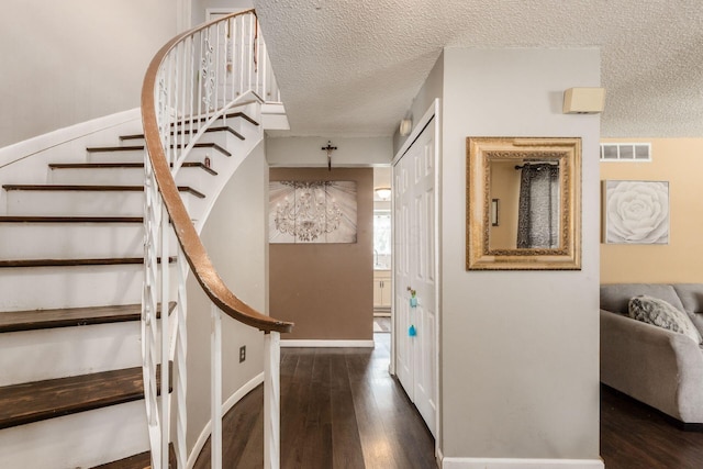 696 Brenton Pl, Columbus, OH 43213 - staircase with a chandelier, a textured ceiling, visible vents, and wood finished floors