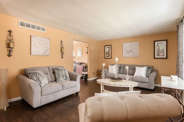 696 Brenton Pl, Columbus, OH 43213 - living area featuring a textured ceiling, baseboards, visible vents, and wood finished floors