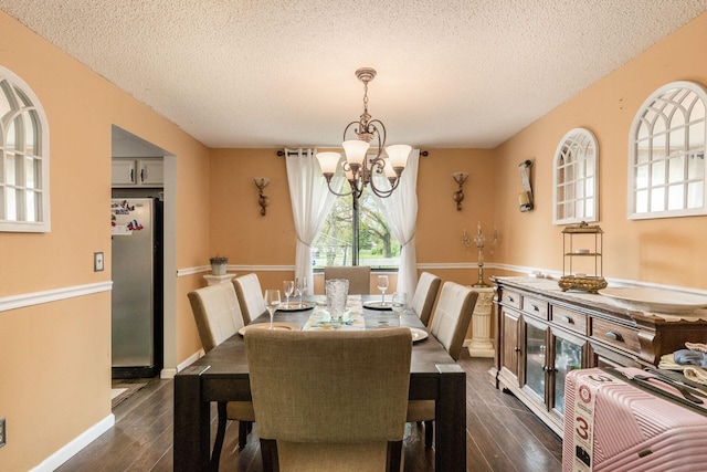 696 Brenton Pl, Columbus, OH 43213 - dining room featuring a chandelier, a textured ceiling, baseboards, and dark wood-style floors