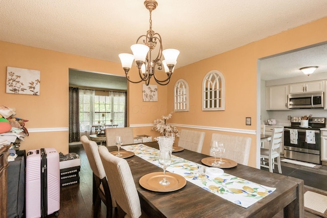696 Brenton Pl, Columbus, OH 43213 - dining area with an inviting chandelier, a textured ceiling, and wood finished floors