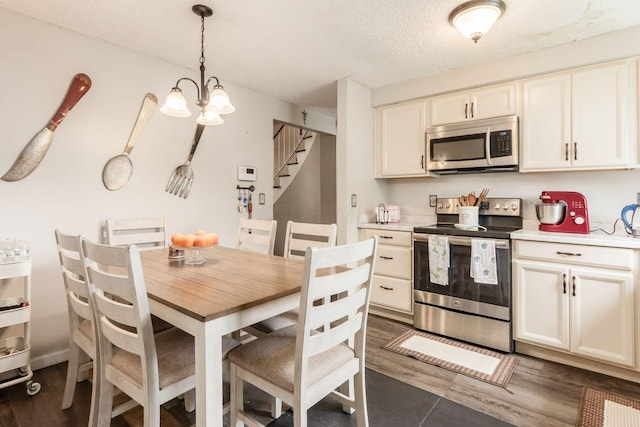 696 Brenton Pl, Columbus, OH 43213 - kitchen with decorative light fixtures, an inviting chandelier, stainless steel appliances, and light countertops