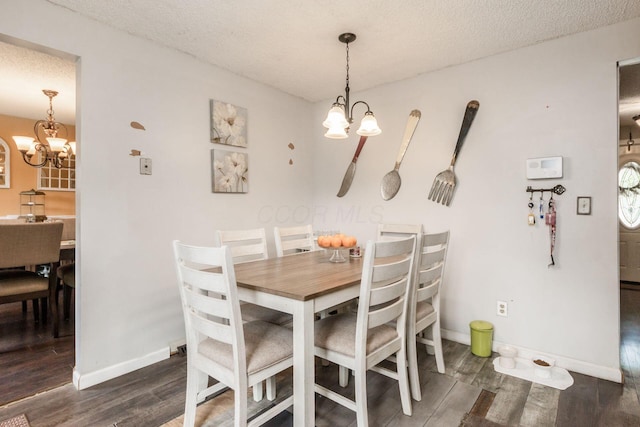 696 Brenton Pl, Columbus, OH 43213 - dining space with baseboards, a chandelier, a textured ceiling, and wood finished floors