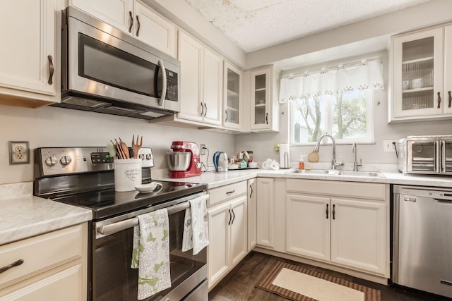 696 Brenton Pl, Columbus, OH 43213 - kitchen featuring a toaster, dark wood-style flooring, a sink, light countertops, and appliances with stainless steel finishes