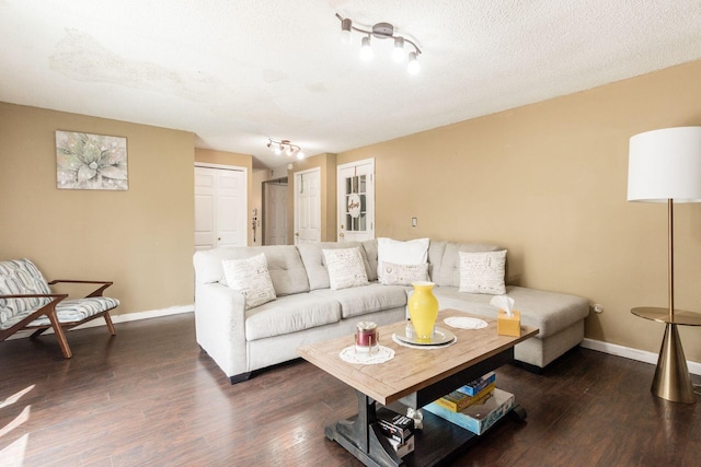 696 Brenton Pl, Columbus, OH 43213 - living room with track lighting, a textured ceiling, dark wood-type flooring, and baseboards
