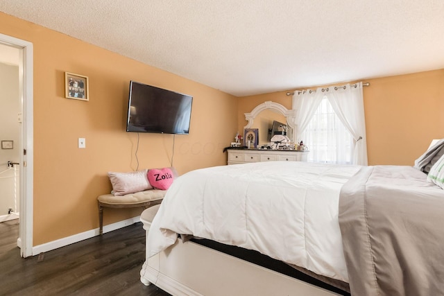 696 Brenton Pl, Columbus, OH 43213 - bedroom with dark wood-style flooring, a textured ceiling, and baseboards