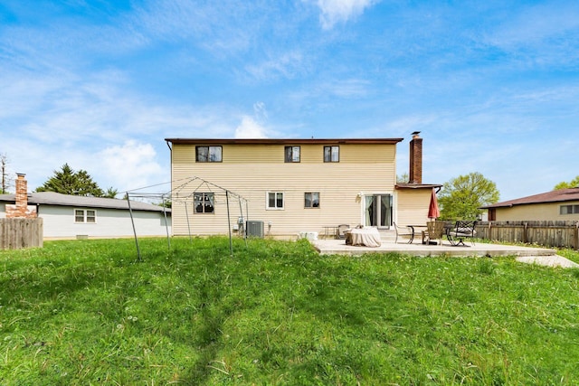 696 Brenton Pl, Columbus, OH 43213 - back of house featuring cooling unit, a yard, a chimney, fence, and a patio area