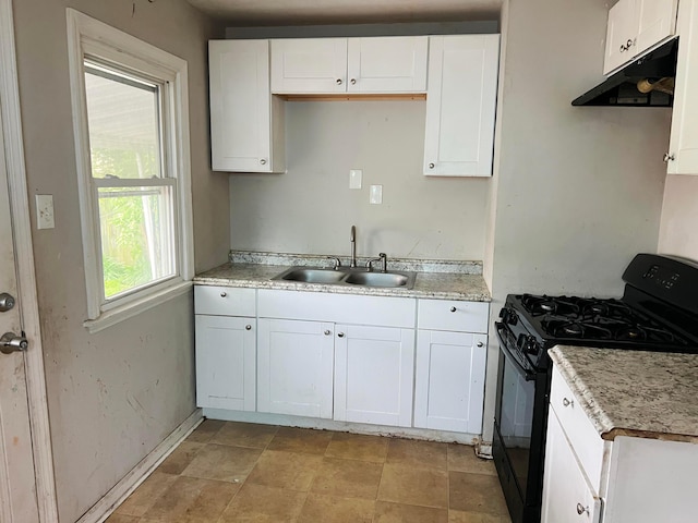 1794 Audrey Rd, Columbus, OH 43224 - kitchen with a sink, black gas stove, under cabinet range hood, white cabinetry, and baseboards