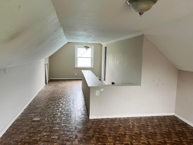 1794 Audrey Rd, Columbus, OH 43224 - additional living space with baseboards, vaulted ceiling, and a textured ceiling