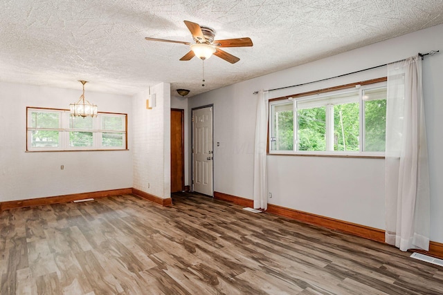 2584 E 5th Ave, Columbus, OH 43219 - empty room featuring wood finished floors, a chandelier, ceiling fan, and a textured ceiling