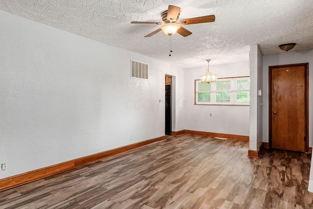 2584 E 5th Ave, Columbus, OH 43219 - spare room with wood finished floors, a chandelier, ceiling fan, a textured ceiling, and a textured wall