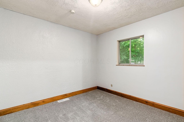 2584 E 5th Ave, Columbus, OH 43219 - spare room featuring carpet floors and a textured ceiling