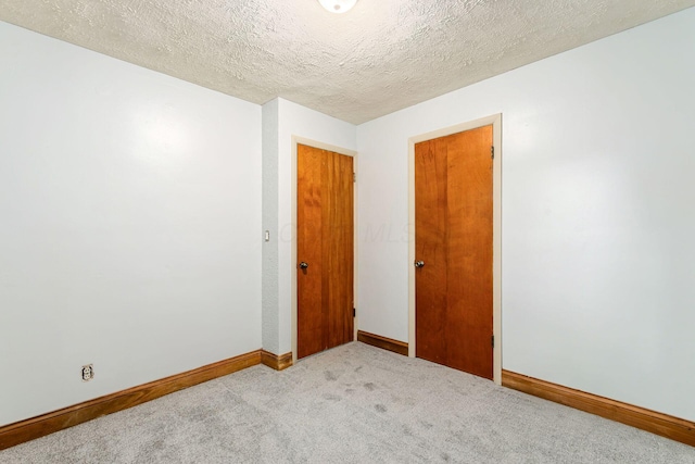 2584 E 5th Ave, Columbus, OH 43219 - unfurnished room featuring light carpet and a textured ceiling