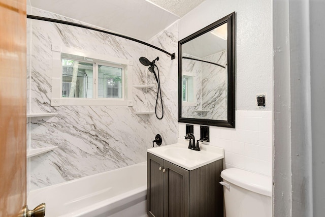 2584 E 5th Ave, Columbus, OH 43219 - bathroom featuring vanity, tub / shower combination, and tile walls