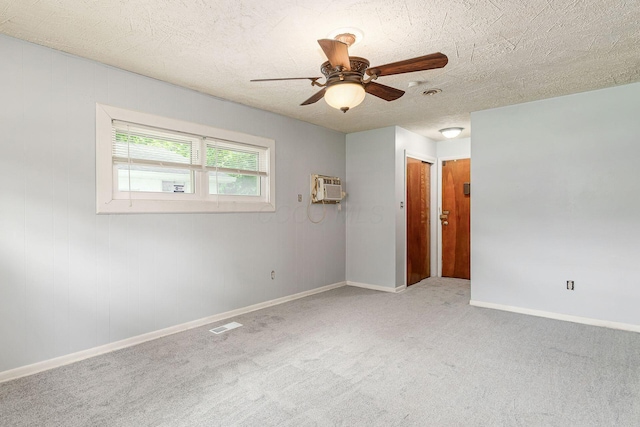 2584 E 5th Ave, Columbus, OH 43219 - carpeted spare room with a ceiling fan, a wall unit AC, and a textured ceiling