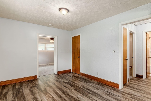 2584 E 5th Ave, Columbus, OH 43219 - empty room featuring wood finished floors, a textured ceiling, and a ceiling fan