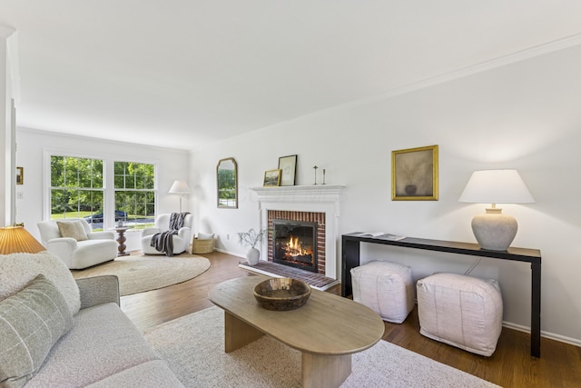 4188 Gavin Ln, Upper Arlington, OH 43220 - living room featuring a brick fireplace, wood finished floors, ornamental molding, and baseboards