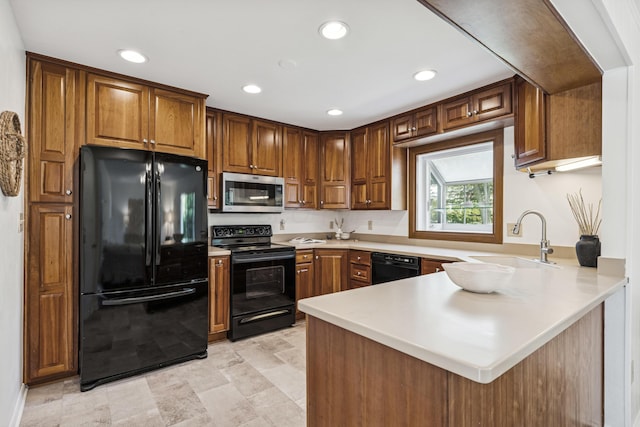 4188 Gavin Ln, Upper Arlington, OH 43220 - kitchen featuring black appliances, a sink, a peninsula, recessed lighting, and light countertops
