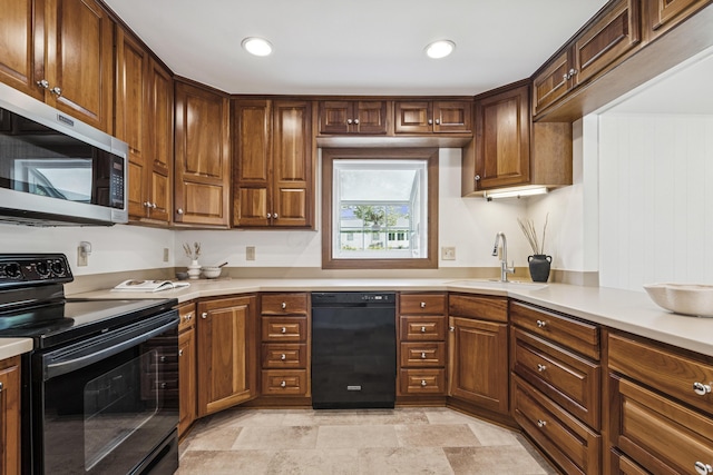 4188 Gavin Ln, Upper Arlington, OH 43220 - kitchen with black appliances, a sink, light countertops, light stone finish flooring, and recessed lighting