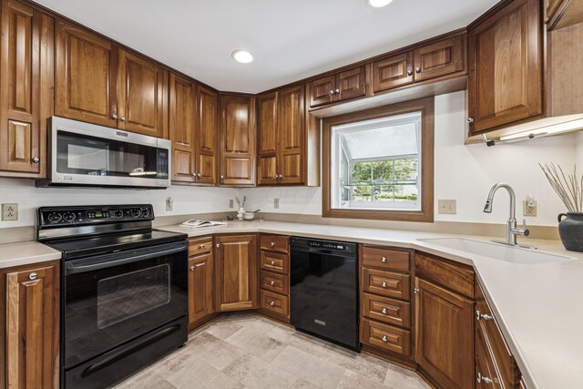 4188 Gavin Ln, Upper Arlington, OH 43220 - kitchen with black appliances, a sink, light countertops, and recessed lighting