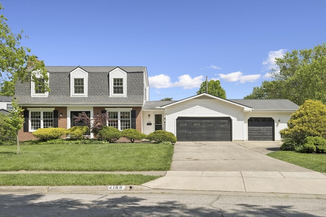 4188 Gavin Ln, Upper Arlington, OH 43220 - colonial inspired home with a garage, a gambrel roof, driveway, a front yard, and brick siding