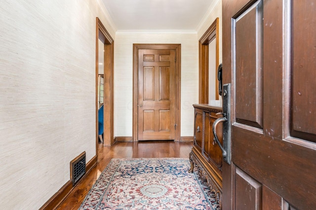 entryway with crown molding, dark wood-style floors, and baseboards