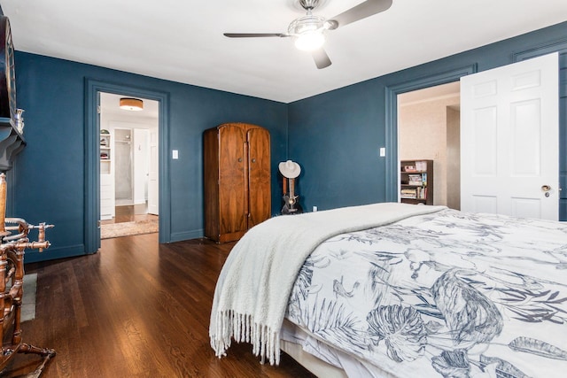 bedroom featuring wood finished floors, ceiling fan, and baseboards