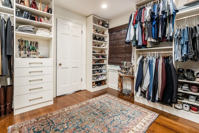 walk in closet with wood finished floors