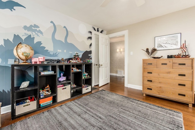 game room featuring wood finished floors, ceiling fan, and baseboards