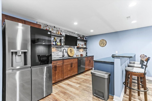 9129 Coe Dr, Plain City, OH 43064 - indoor wet bar featuring stainless steel fridge, dishwasher, light wood-style floors, recessed lighting, and tasteful backsplash
