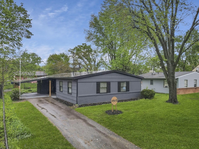 4502 Aragon Ave, Columbus, OH 43227 - view of front of home with brick siding, aphalt driveway, a front lawn, and a carport