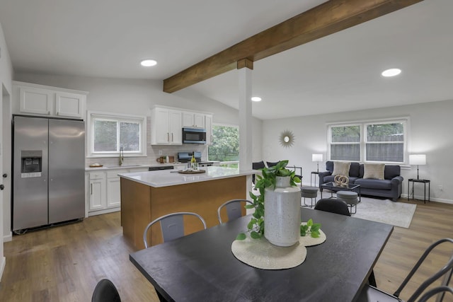 4502 Aragon Ave, Columbus, OH 43227 - dining area featuring wood finished floors, vaulted ceiling with beams, a healthy amount of sunlight, and recessed lighting
