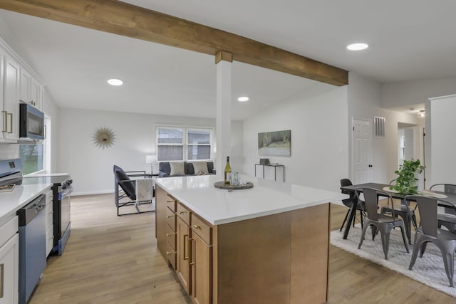 4502 Aragon Ave, Columbus, OH 43227 - kitchen with stainless steel appliances, visible vents, light countertops, a center island, and light wood-style floors