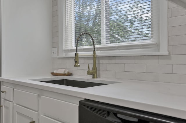 4502 Aragon Ave, Columbus, OH 43227 - interior details featuring a sink, tasteful backsplash, white cabinetry, and dishwasher