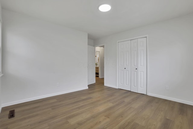 4502 Aragon Ave, Columbus, OH 43227 - unfurnished bedroom featuring a closet, wood finished floors, visible vents, and baseboards